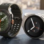 Two smartwatches, one dark green, the other white.