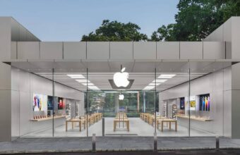 Façade en verre d'un Apple Store moderne, logo lumineux.